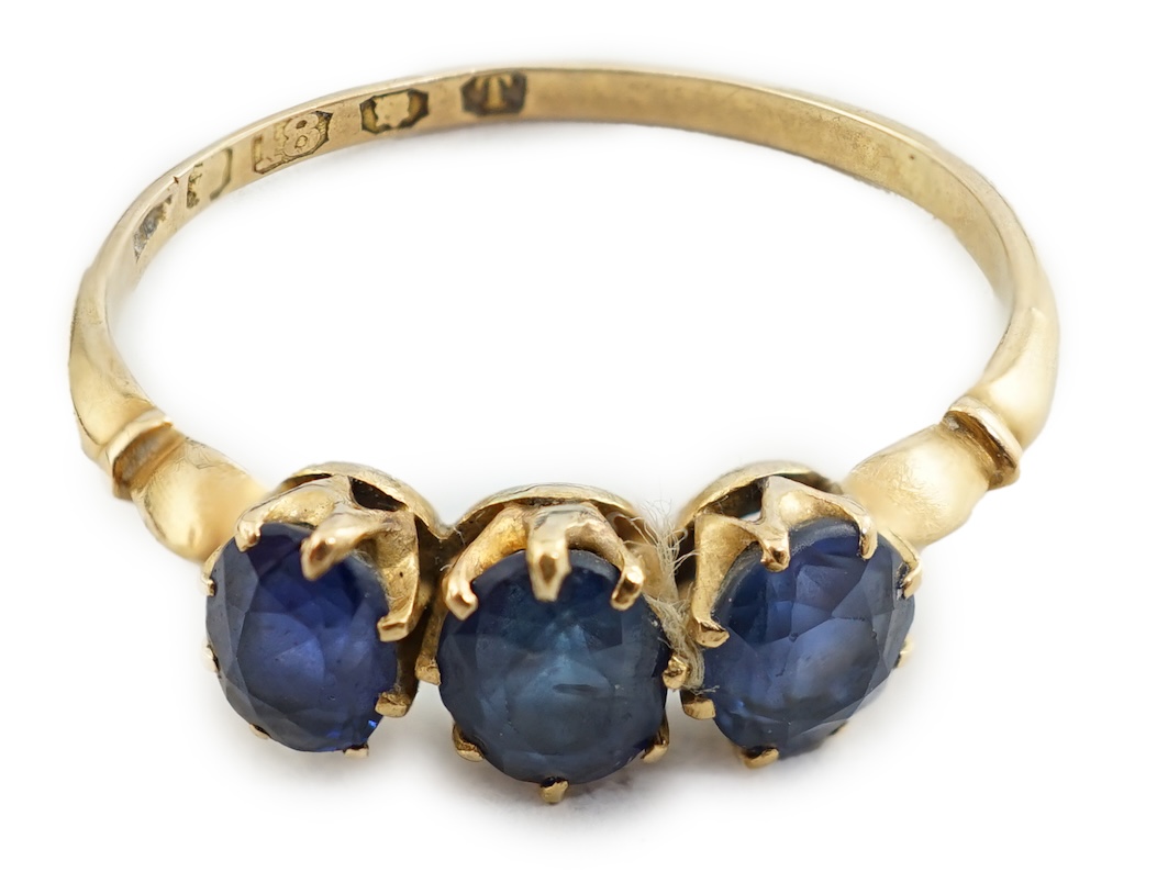 A late Victorian 18ct gold and three stone oval cut sapphire set ring, size P/Q, gross weight 1.9 grams. Condition - fair